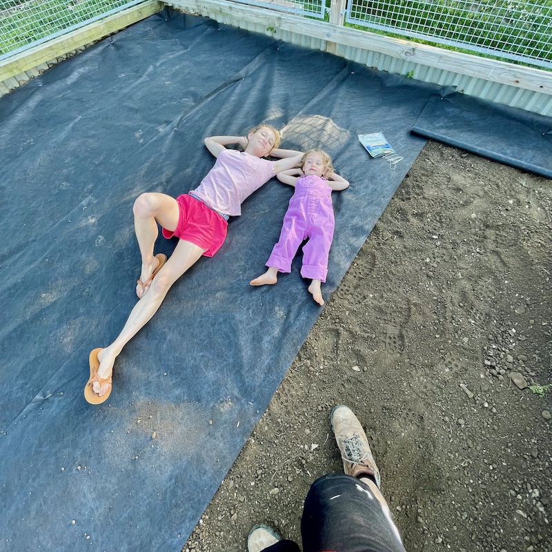 Mom and daughter laying in garden