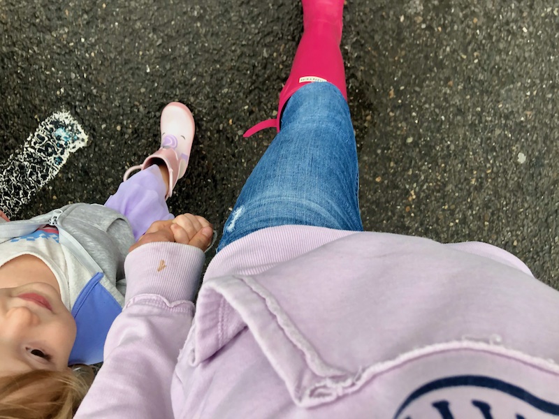 Mom and daughter wearing rain boots while walking