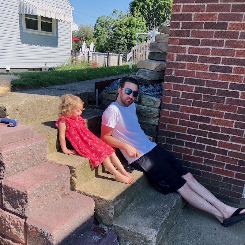 Father and daughter sitting on steps