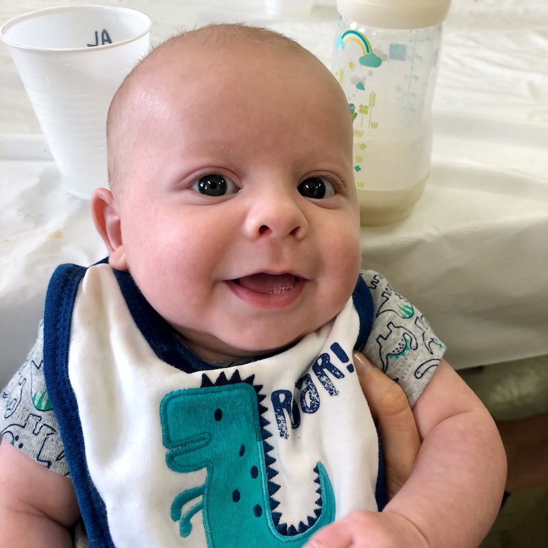 Baby boy smiling with bib