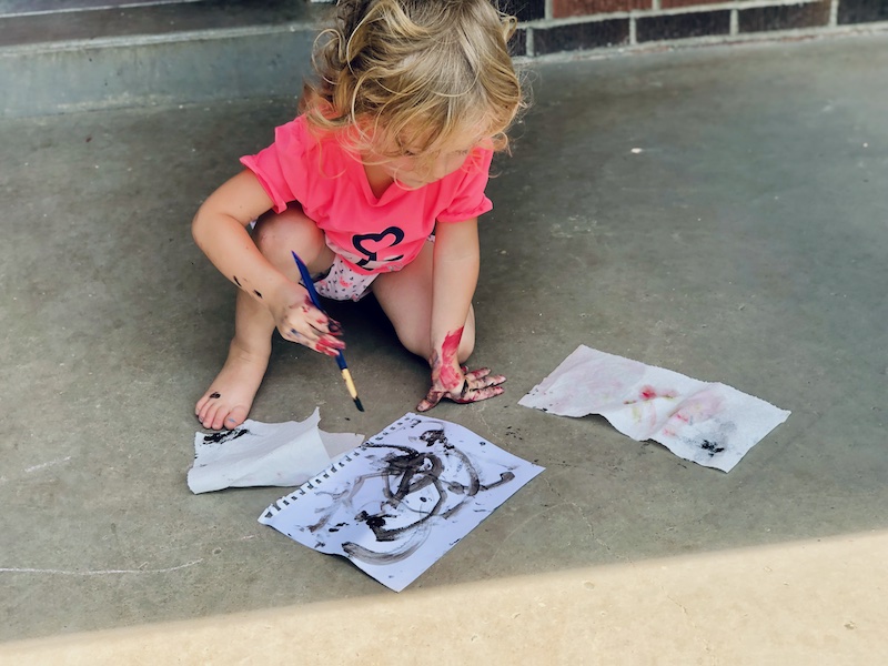 Toddler painting with black paint