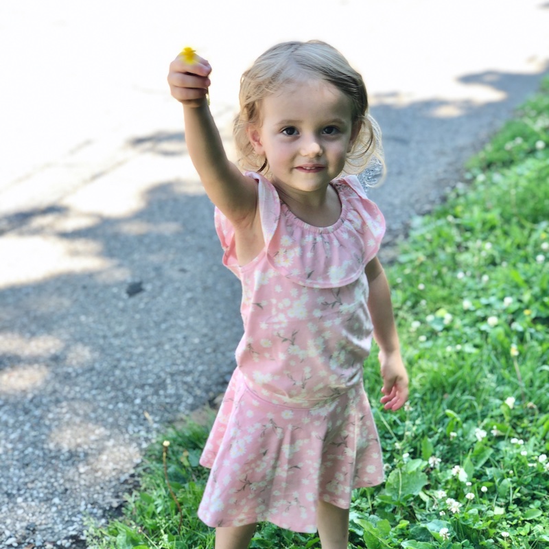 Little girl holding dandelion