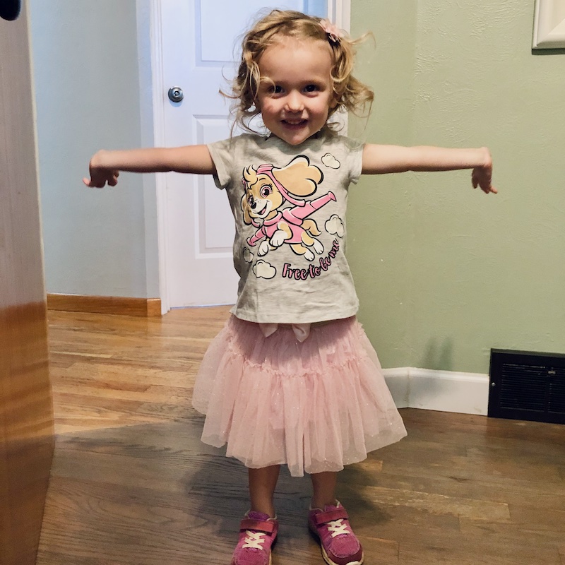 Toddler girl wearing skirt and Paw Patrol shirt