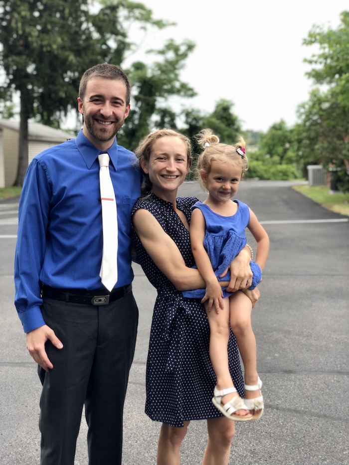 Mom and dad with toddler in blue clothes for family picture