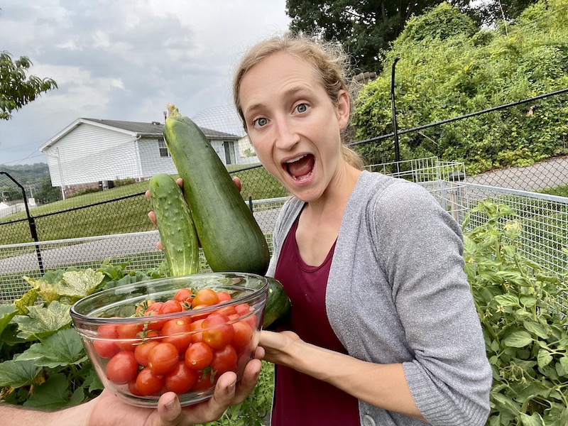 Girl holding garden produce from vegetable garden