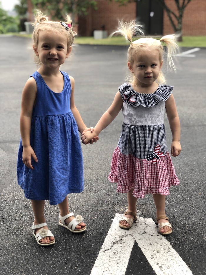 Toddler girls holding hands in Fourth of July dresses