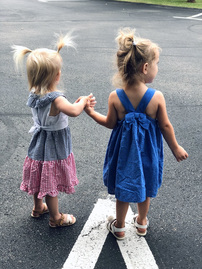 Toddlers holding hands in Fourth of July dresses