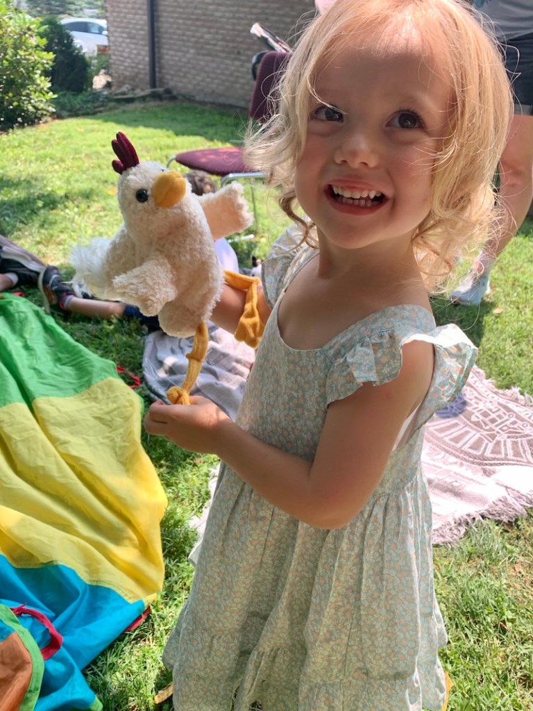 Toddler girl with chicken puppet