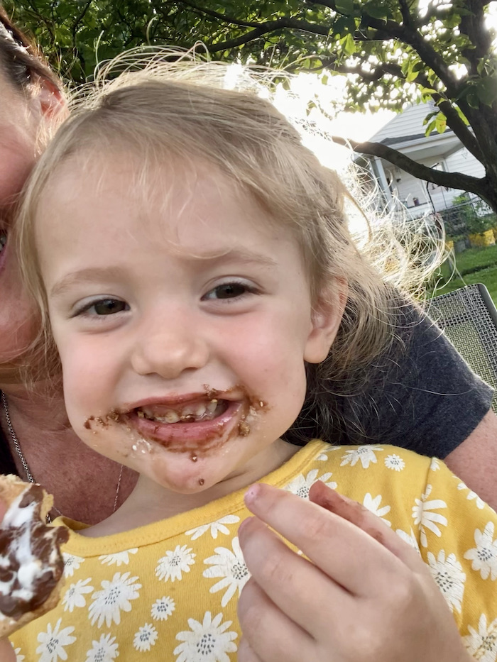 Toddler girl eating s'mores 