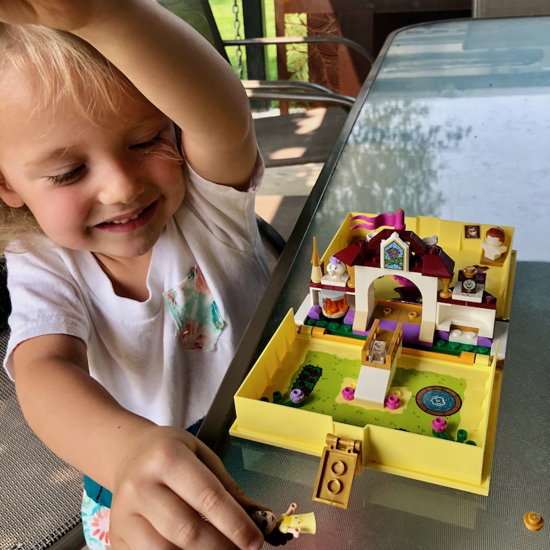 Toddler girl playing with Disney Princess Lego Kit