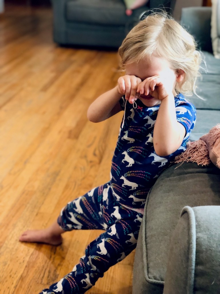 Toddler girl in unicorn pajamas