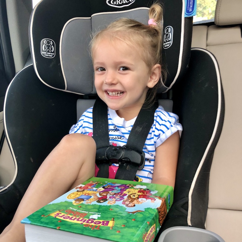 Toddler sitting in carseat with Bible