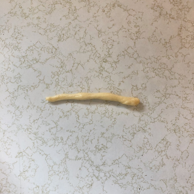 Challah bread dough shaped into a rope to make a wreath