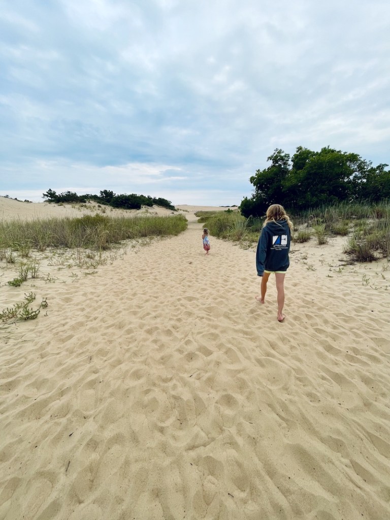 Mom and daughter walking to sand dunes at Jockey's Ridge State Park in Nags Head North Carolina 