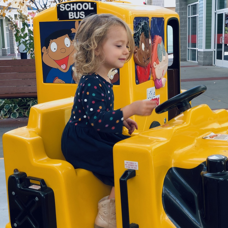 Toddler riding construction mechanical toy at shopping center in Pittsburgh, PA