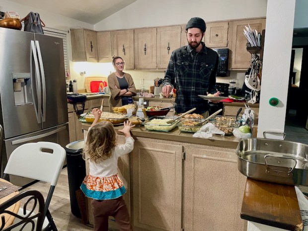 People filling their plates on Thanksgiving