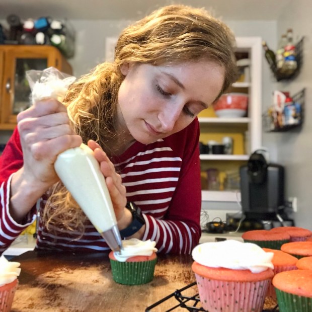 Girl frosting cupcakes
