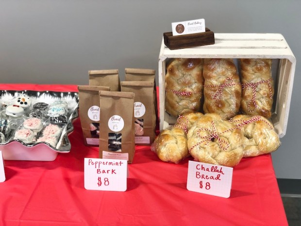 Challah bread and peppermint bark from Etsy shop on table at holiday market in Pittsburgh, PA