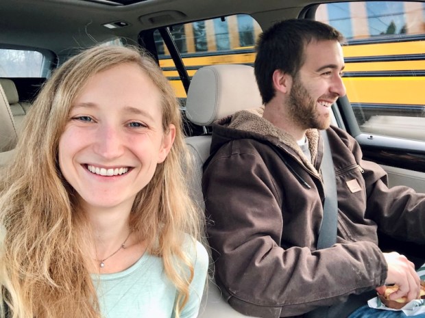 Wife taking selfie while husband drives