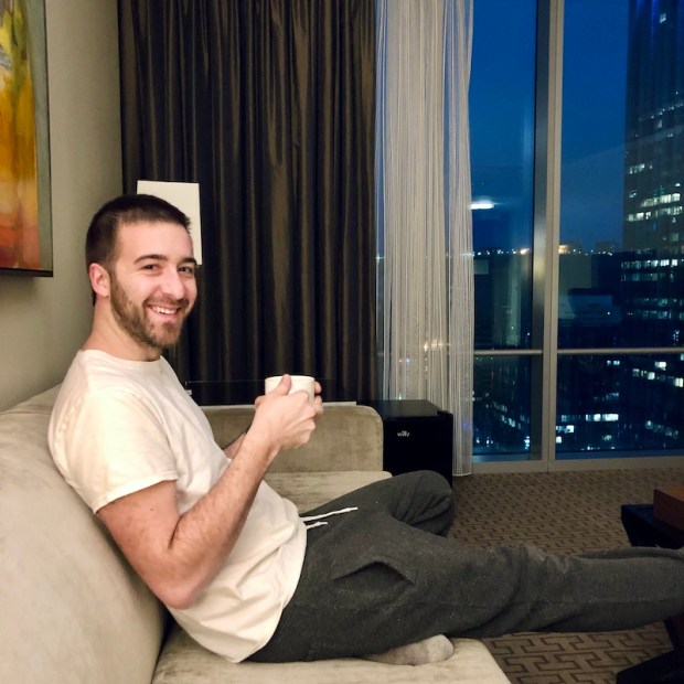 Sitting on couch drinking coffee in suite at Fairmont Hotel in Downtown Pittsburgh, PA