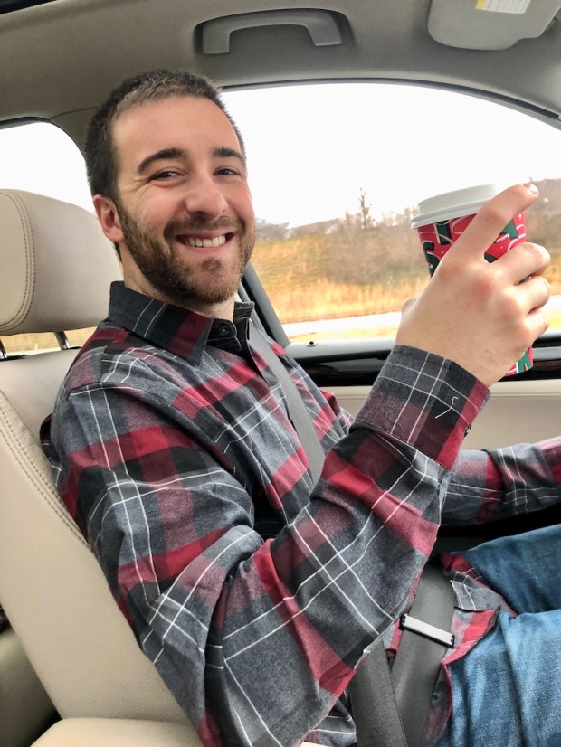 Guy drinking Starbucks coffee