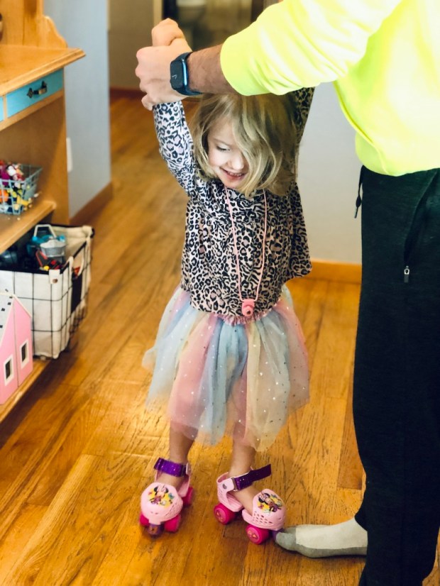 Toddler girl wearing Minnie Mouse roller-skates
