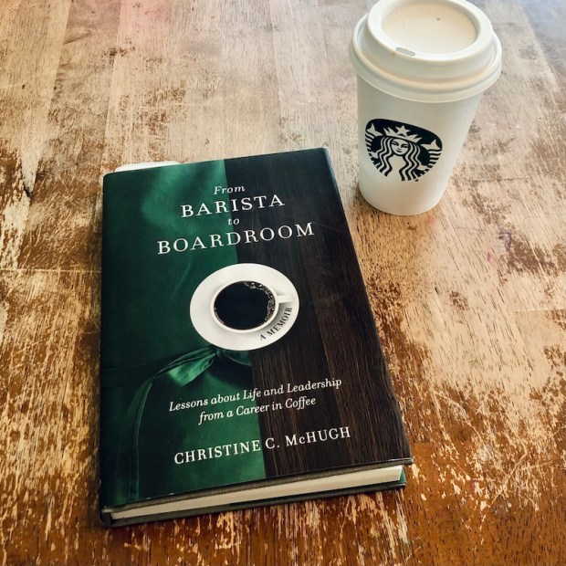 From Barista to Boardroom book with Starbucks coffee sitting on table