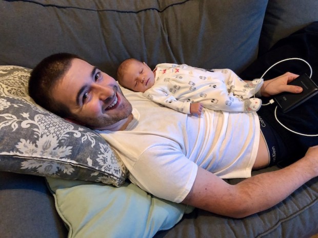 Dad with newborn laying on his chest