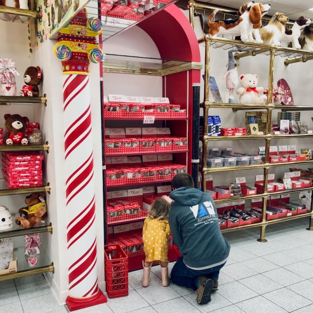 Dad and daughter looking at chocolate a Sarris Candies in Canonsburg, PA