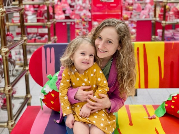 Mom and toddler sitting on bench at Sarris Candies in Canonsburg, PA just outside of Pittsburgh