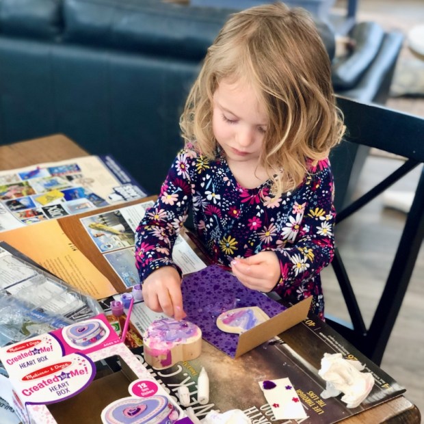 Toddler girl doing Made By Me Heart Shaped Box by Melissa and Doug