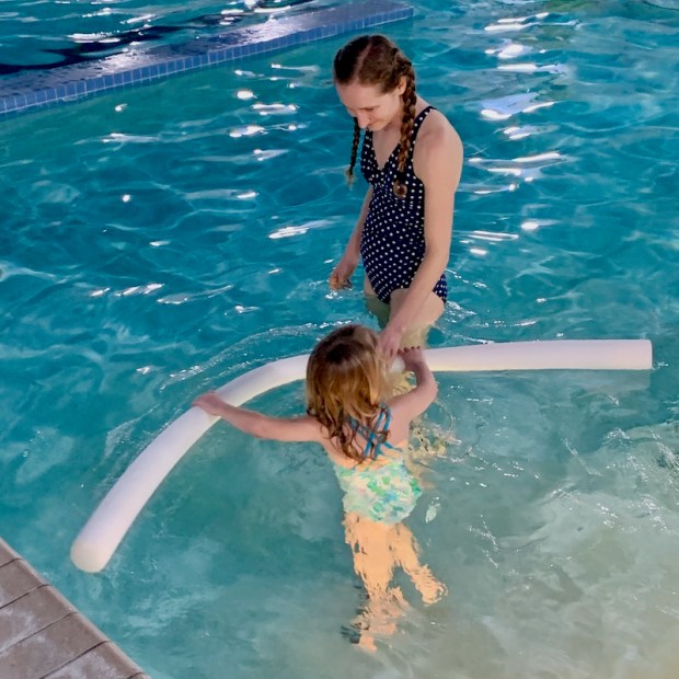 Mom and daughter swimming in indoor pool at Outer Banks YMCA
