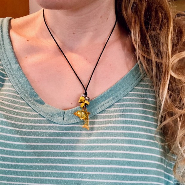 Mom accidentally wearing child's dolphin necklace