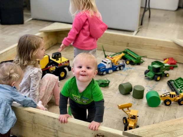 Baby boy in indoor sand box