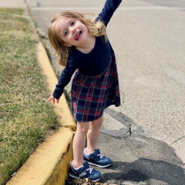 Toddler girl standing on road