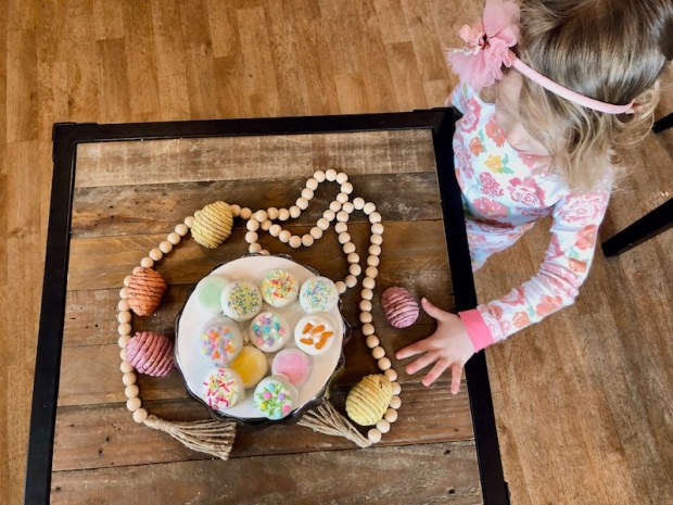 Toddler girl looking at Easter chocolate covered Oreos