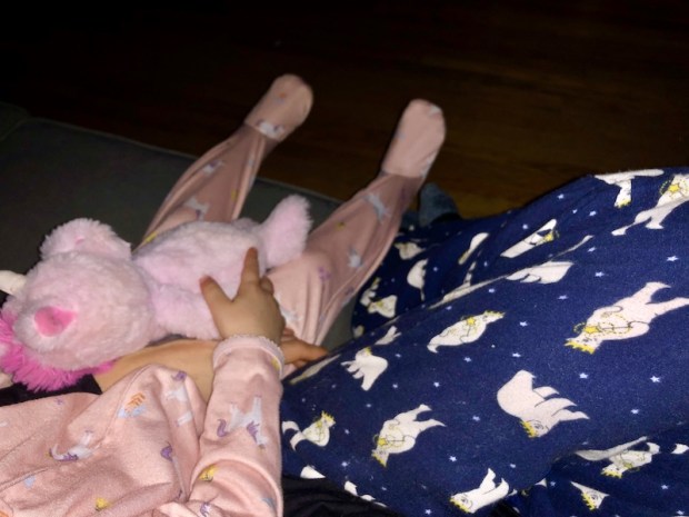 Mom and toddler sitting on couch together