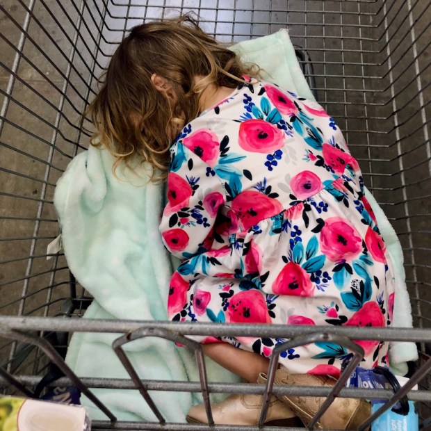 Toddler sleeping in shopping cart