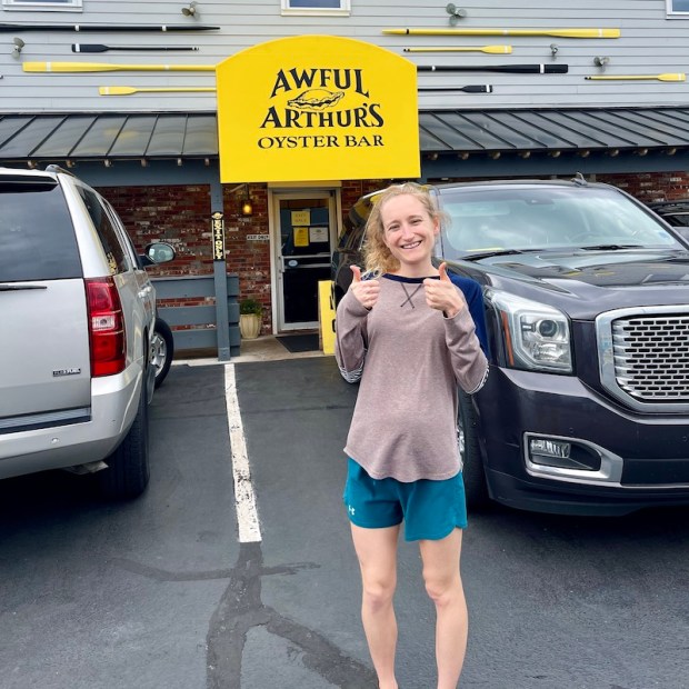 Girl standing in front of Awful Arthur's Oyster Bar in Kill Devil Hills, NC