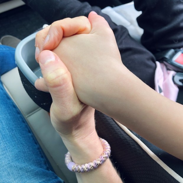 Mom holding hands with toddler