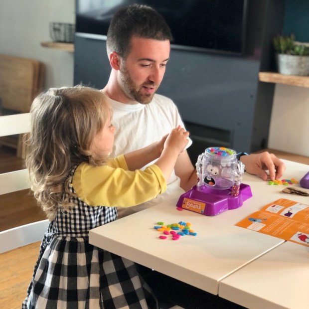 Dad and child playing Don't Spill the Beans game
