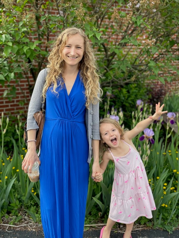Mom and toddler daughter holding hands