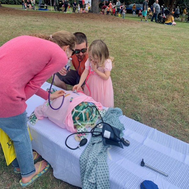 Playing doctor with a stuffed sea turtle at Kidsfest
