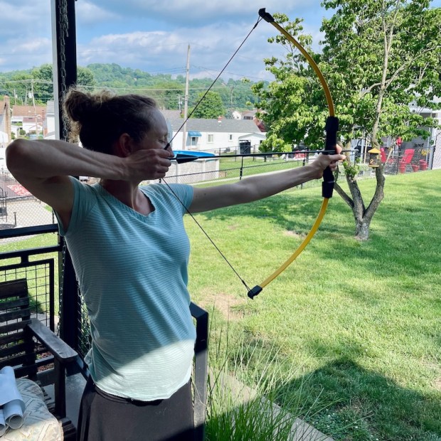 Girl shooting a recurve bow