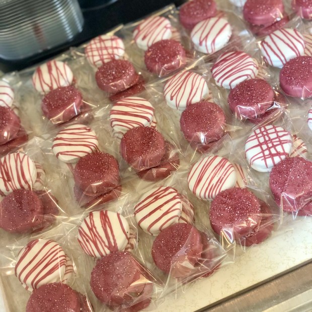 Maroon and white chocolate covered Oreos