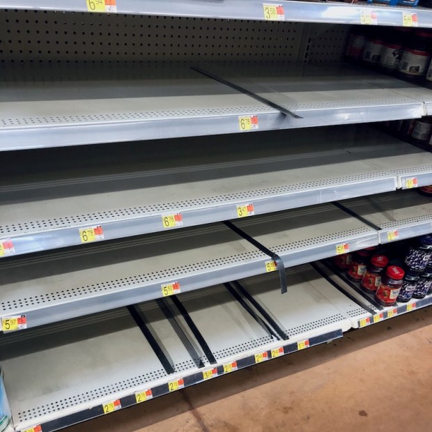 Empty peanut butter shelves at Walmart