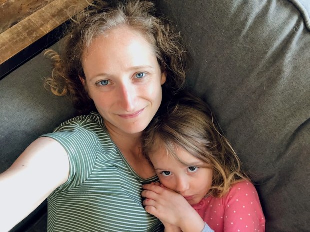 Mom and daughter laying on couch selfie