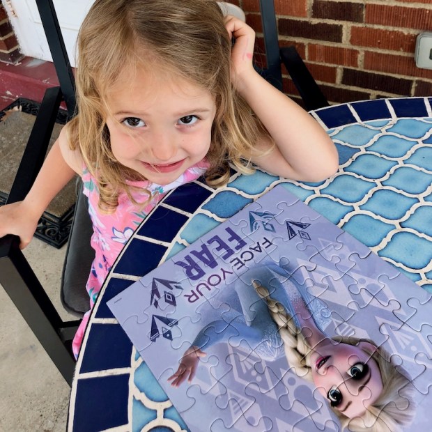 Girl with 48 piece Frozen puzzle