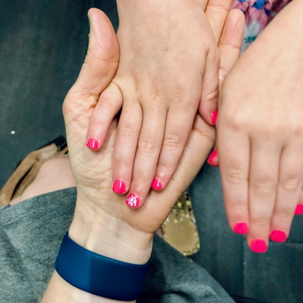 Little girl manicure with pink polish and flower design