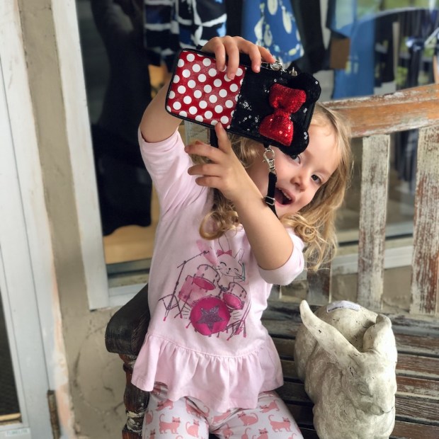Little girl with Minnie Mouse purse
